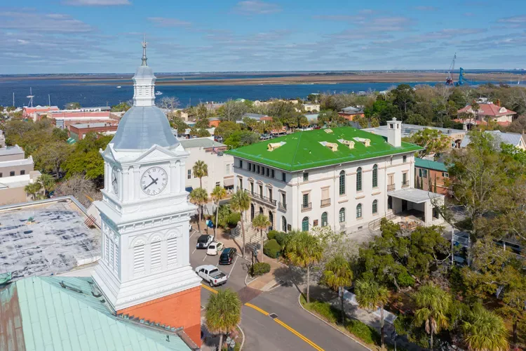 Aerial view of downtown Fernandina Beach with the historic courthouse clock tower and green-roofed post office near the waterfront.